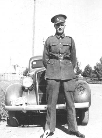Harry Tucker posing in front of a car in the 1940s.