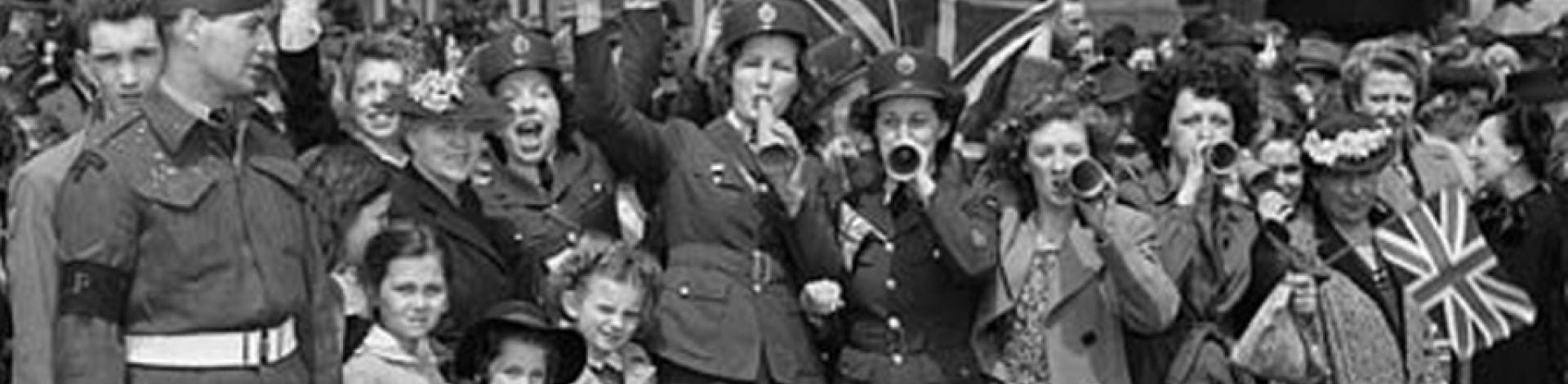 Black and white photo of soldiers celebrating the end of World War Two.