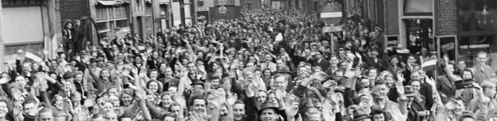 Black and white photo of a crowd cheering in the Netherlands.