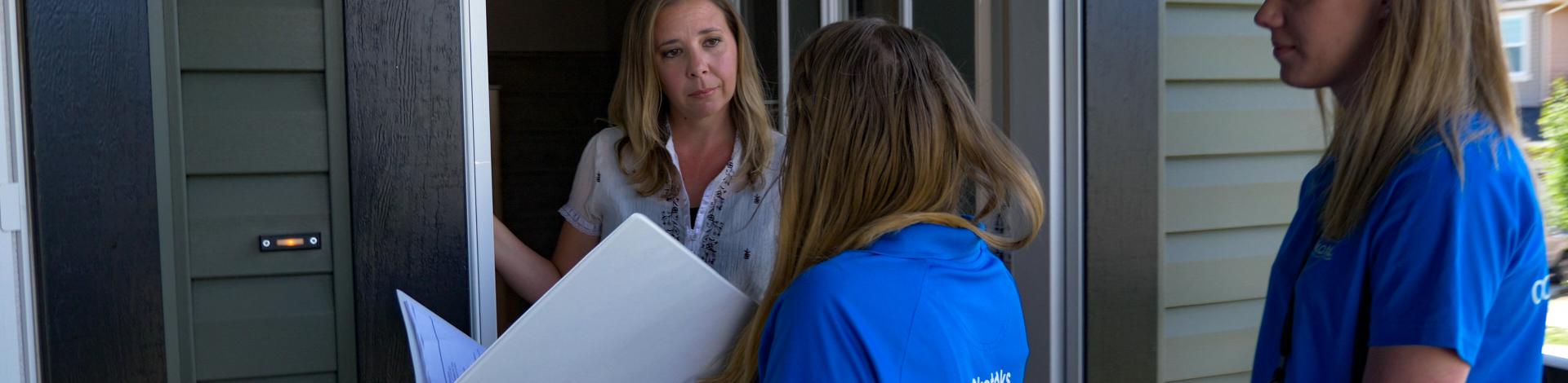 Conservation Educators doing home visits with residents regarding water and energy conservation