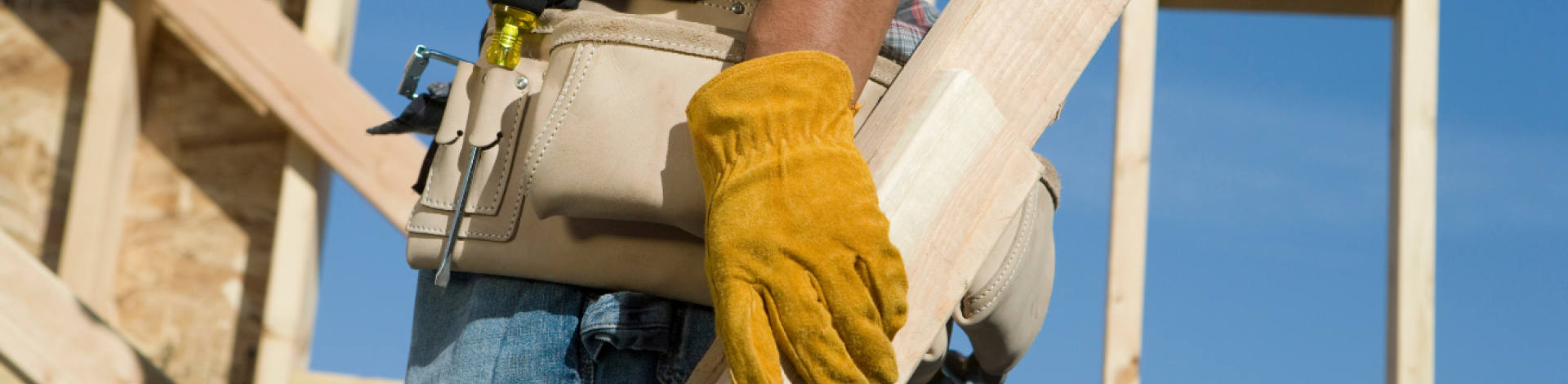 man holding building plans in construction zone