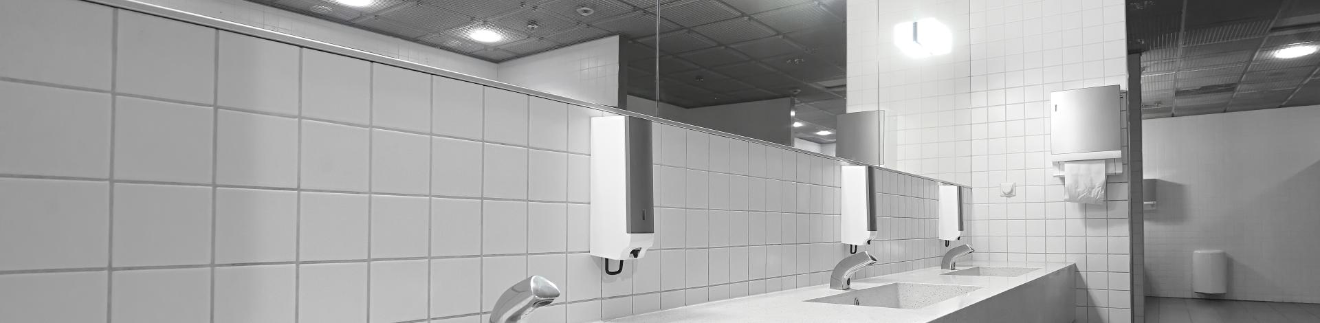 public restroom washroom with automated low flow water faucets
