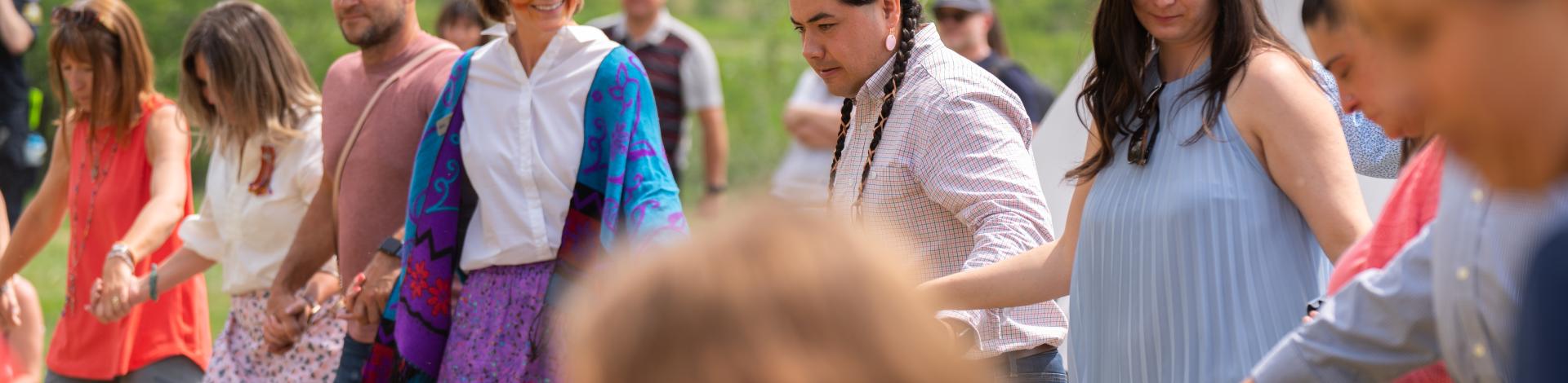 Tipi Transfer Ceremony with members of the community participating in a traditional dance circle