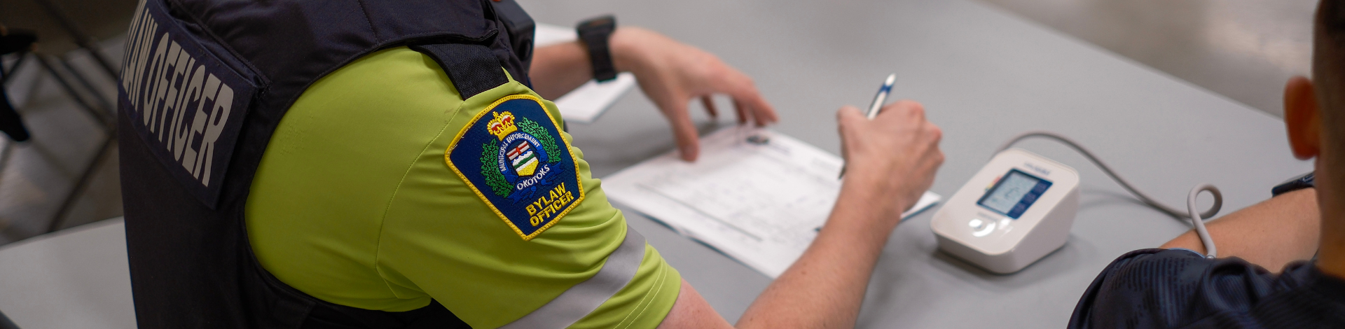 Okotoks bylaw officer takes the heart rate of a PARE participant