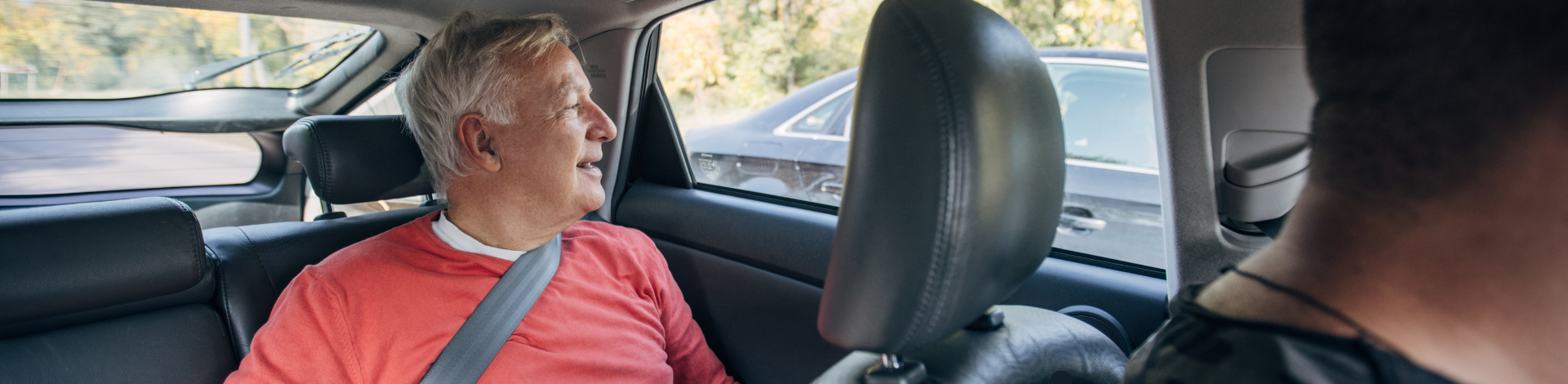 senior man in back of vehicle