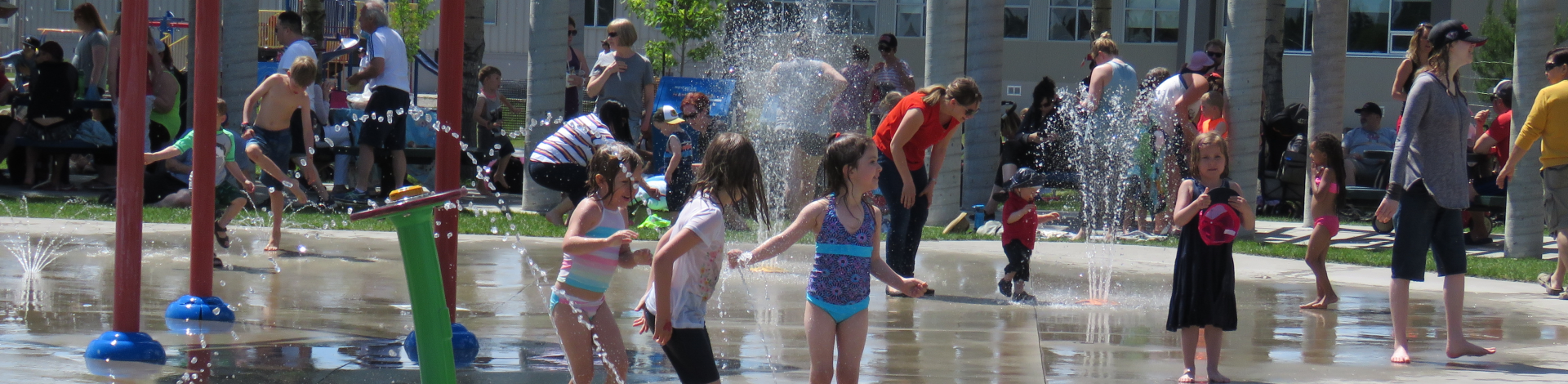 Children standing in water at outdoor water spray park