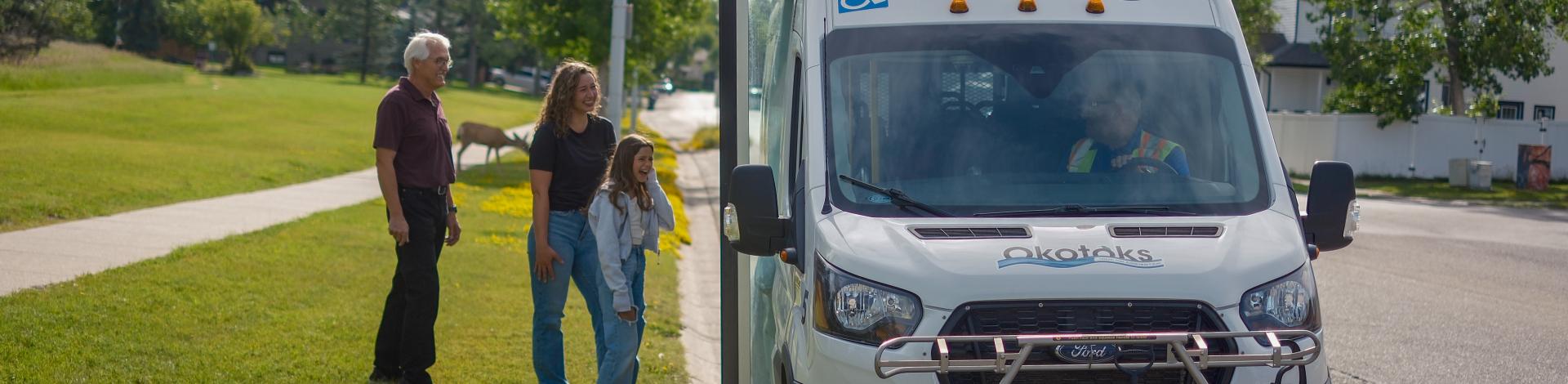 People waiting to get on Okotoks transit vehicle