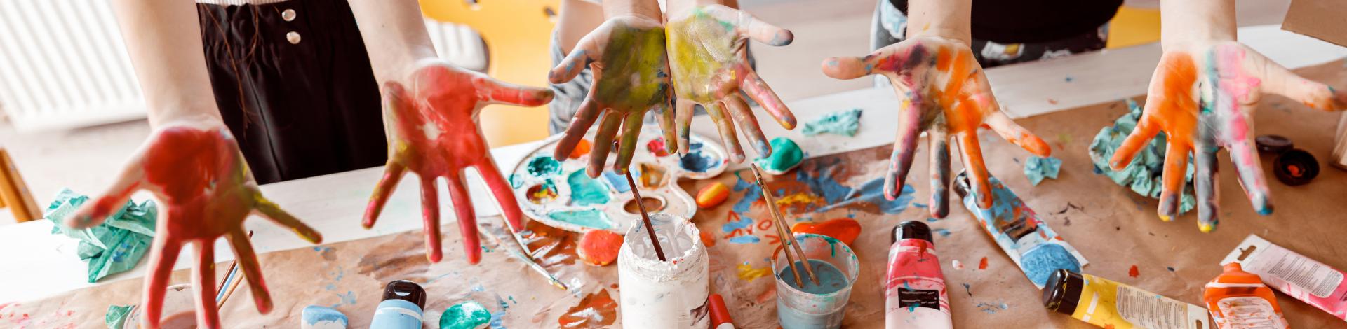 children showing hands painted with watercolours