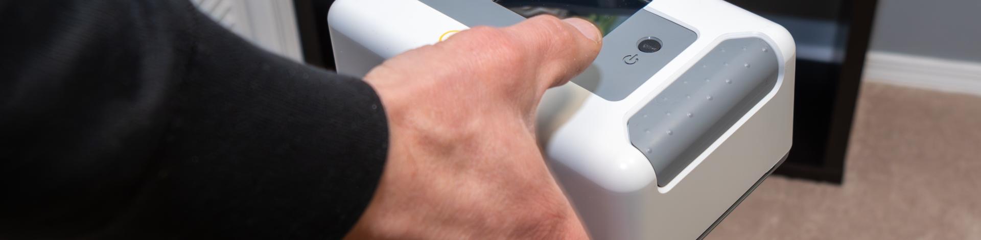 hand holding Radon monitor in bedroom of a home