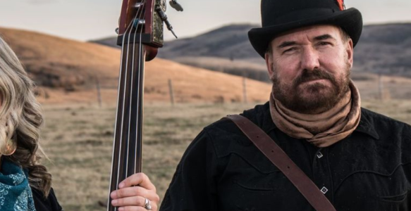two members of Over the Moon stand in a field 
