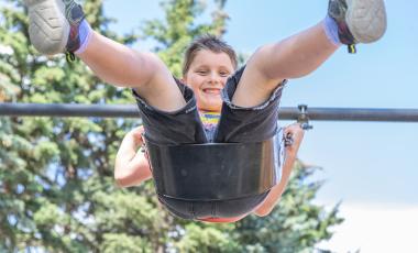 Child playing on swing