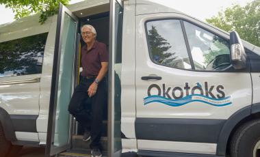 Gentleman getting off of Okotoks Transit van