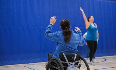 person in wheel chair taking dance lessons