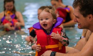 child and adult swimming