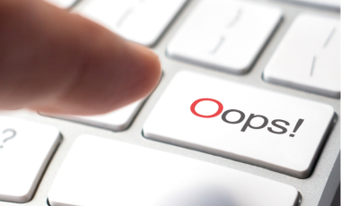 finger pressing oops button on keyboard