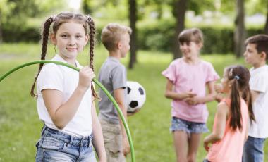 girl posing with hula hoop with friends