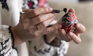 woman decorating Ukrainian Easter egg