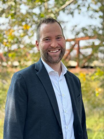 Smiling man with bridge in background
