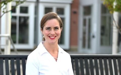 Woman smiling in front of bench