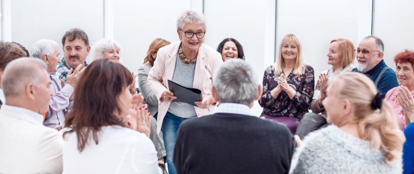 older adult speaking to audience