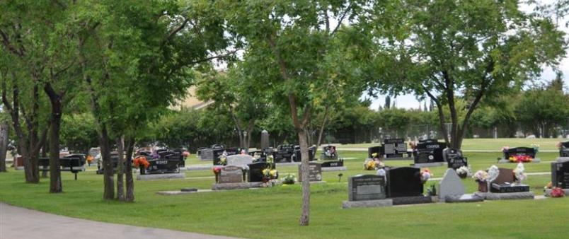 Okotoks cemetery, green trees and grace stones 
