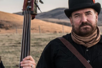 two members of Over the Moon stand in a field 