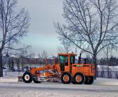 Grater plowing snow on main Okotoks roads