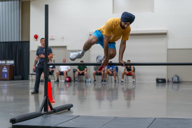 Participant jumps over obstacle in PARE training