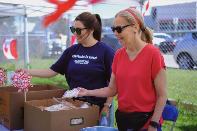 two town staff hand out cookies 