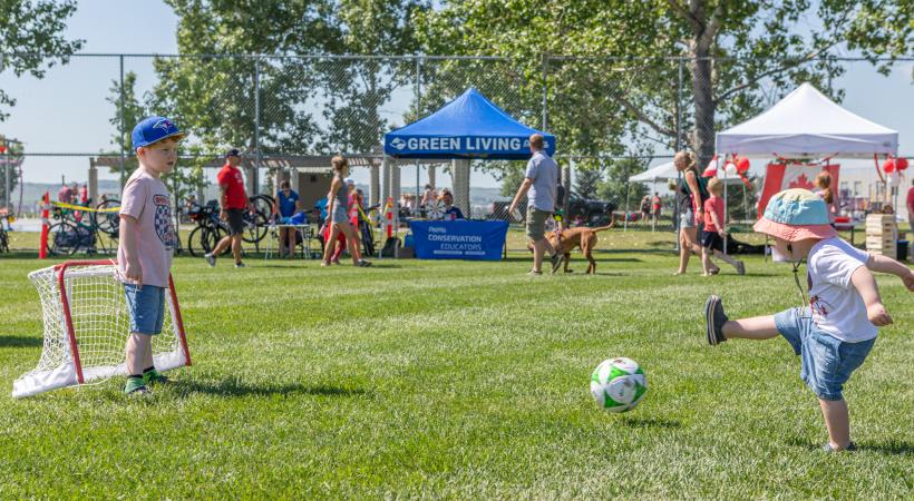 a youth kicks a ball in a feild