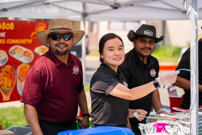 restaurant staff serving food samples at Taste of Okotoks 