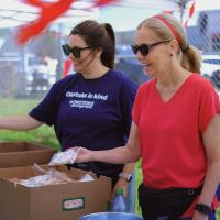 two town staff hand out cookies 