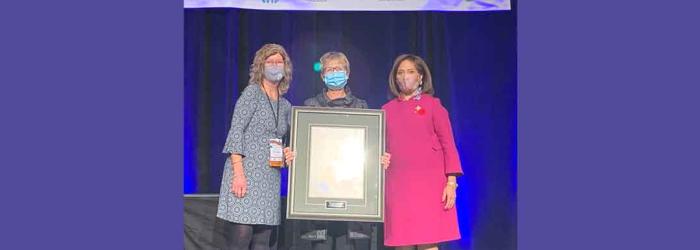 Elaine Robertson accepts award