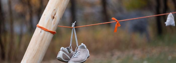 Pair of shoes hunt on orange string at Truth and reconciliation memorial site