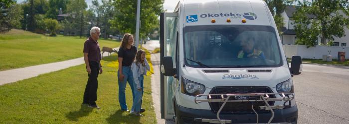 People waiting to get on Okotoks transit vehicle