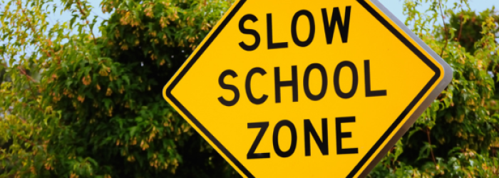 slow school zone sign