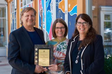 2022 Annual Report winning recipients with plaque