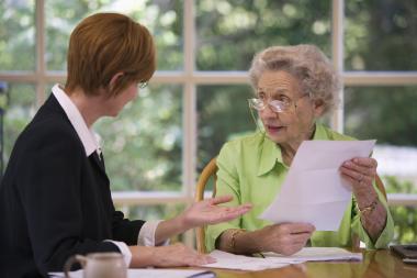 elderly woman reviewing document